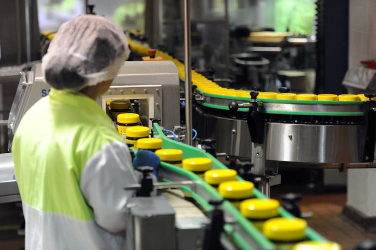 A woman working on a production line